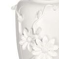 Zoomed detail of porcelain vase daisy flower petals and textured centers in white