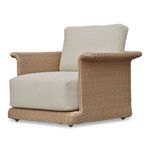 Meredith chair angled view highlighting curved armrests and plush beige cushions