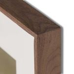 Close-up of rustic walnut frame edge showing wood grain and mitered corner details.