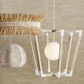 Pendant hanging next to two natural pendants with beaded and straw textures, wall background