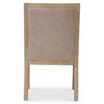 Rear view of Prado arm chair in darker wood finish with full taupe fabric upholstery