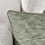 Close-up of Sharma pillow corner on sofa, focusing on fabric texture against soft upholstery