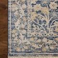 Detailed close-up of rug corner highlighting the floral border and texture on wood floor