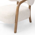 Close-up of lower front oak leg and thick ivory seat cushion seam texture