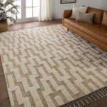 Emre rug styled in living room with leather sofa, wooden floor, and natural light from window