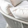 Rear angle highlighting plush back throw pillows and rope frame curvature on light fabric version