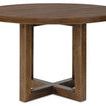 round dining table viewed from a slight angle showing thick tabletop edge and rectangular pedestal legs