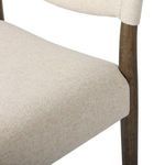 Close-up detail of back seat upholstery and wood frame joint