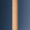 Close-up of woven grasscloth texture on cylindrical stem with brass cap at bottom