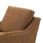 Close-up on Lynne chair showing thick back cushion and soft pleated arm detail