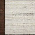 Close-up of Jamie Ivory Dove Rug corner on dark wood floor revealing detailed fiber texture and woven pattern