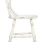 Side profile highlighting gently curved backrest and seat with distressed finish on spindle back counter stool