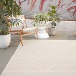 Outdoor patio view of rug showing right edge with modern chair and layered plant pots