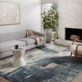 Spirit Indigo / Ivory rug styled in a bright modern living room with gray sofa and fireplace