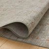 Side view of Ida Spa rug rolled to display thin, flexible construction