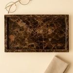 Brown Emperador marble tray styled on beige surface with glasses and cloth nearby