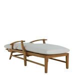 Side view of chaise with white cushions showing padded seat and backrest