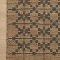 Top view detail of rug edge on hardwood floor showing tight weave and graphite grid pattern