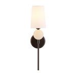 Front view of lighted sconce showing soft light diffusion through linen shade