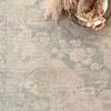 Hand-woven Priya Bone Bluestone modern rug with delicate floral motifs in muted blue and beige tones