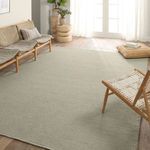 solid taupe and gray rug styled in sunlit living room with wood floor and natural fiber chair and pouf