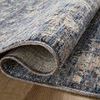 Close-up of folded rug edge showing detailed texture and double-stitched binding in blue and beige