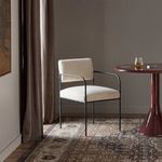 Fenn Dining Chair styled in room setting with vintage rug and side table beside window with drapes
