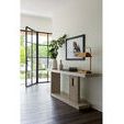 Herrero Console in bright room setting with natural light, styled with vases, books, and artwork above