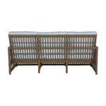 Back view of the sofa highlighting open woven wicker structure without cushions