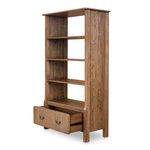 Caroline bookcase in three-quarter view with bottom drawer partially open showing interior