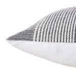 Close-up of pillow corner highlighting textured woven fabric and stitching