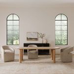 Dining room setup with Barrow rolling chairs, dining table, and large arched windows