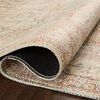 Close-up of the underside showing flexible woven backing and rolled edge of apricot patterned rug