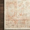 Close-up of plush pile and muted terracotta pattern detail on Rosette Ivory Terracotta Rug on dark wood floor