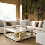 Close corner view of sectional in sunlit room with large window and plush light rug, showcasing texture and cushion mix