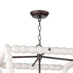 Ceiling mount and adjustable chain in dark metal, connecting to the bead-framed lantern body