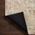 Rug corner flipped to show smooth black underside with light beige stitched edges