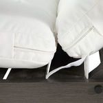 Close-up of white cushion edges with stitching and zipper detail secured to chaise frame