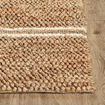 Corner view showing thickness and looped weave detail of natural fiber Barcelona rug on wood floor