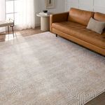 rug styled in modern living room with brown leather sofa, round side table, and natural light through window
