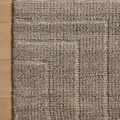 Close-up of Asha Bark Rug corner on wooden floor highlighting woven pattern and texture