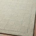 Close-up of corner with diamond and grid pattern in soft sky blue on Francis Silver / Sky Rug over wood floor