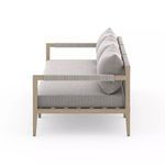 Side profile emphasizing rope-wrapped armrest and thick seat cushion texture