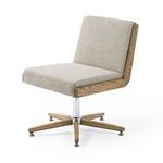 Carla Desk Chair angled right in minimal setting with tan wood paneled wall and light desk