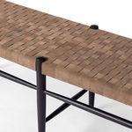 Detail of woven leather straps forming the textured seat of Wyatt Bench
