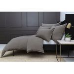 Side view of Waverly Duvet Set styled on a black bed frame against dark paneled wall