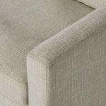 Close-up of cushioned armrest and seat fabric texture illustrating dense foam padding