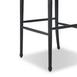 Close-up of black-finished chair legs with rounded ends and brace supports on Fayth stool