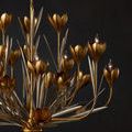 Dimly lit view of chandelier emphasizing warm gold tones and candle-style bulbs