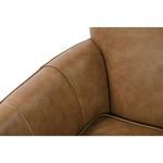 Close-up of inner armrest and seat cushion corner highlighting smooth leather and piping detail